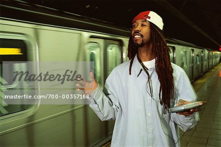 Man with Portable Audio Player By Subway