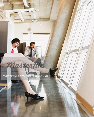 Men Staring at Woman's Legs in Office