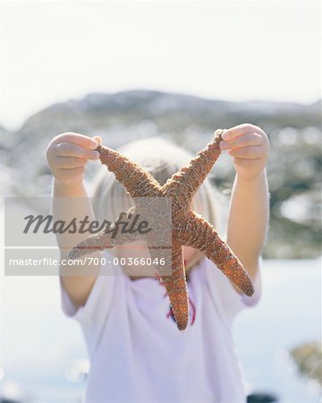 Child Holding Sea Star