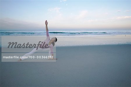 Woman Doing Yoga on Beach