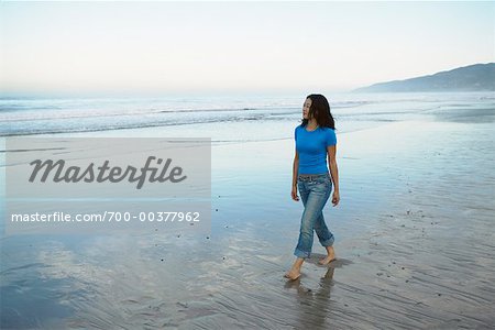 Woman Walking on Beach