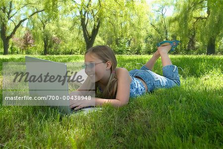 Girl Using Laptop in Park