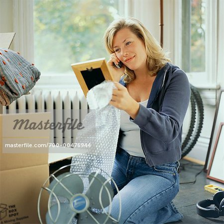 Woman Using Cellular Telephone and Looking at Picture