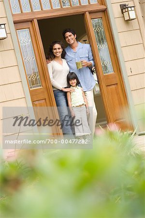 Portrait of Family in Doorway of Home