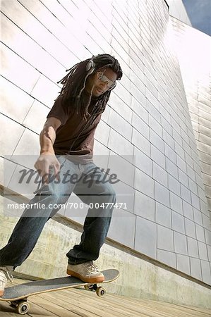 Man Skateboarding and Listening to Music