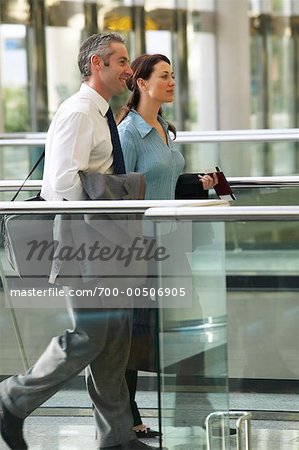 Businessman and Businesswoman at Airport