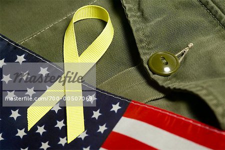 Yellow Ribbon on American Flag and Military Uniform