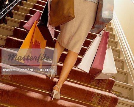 Woman Climbing Stairs, Carrying Shopping Bags