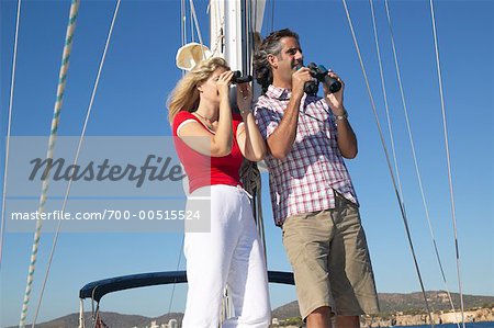 Couple Using Binoculars in Boat