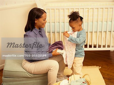 Mother and Daughter Folding Laundry