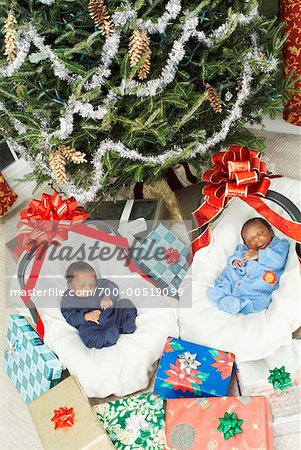 Newborn Twins in Matching Bassinets at Christmas