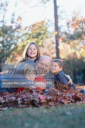 Children with Grandfather in Fall Leaves