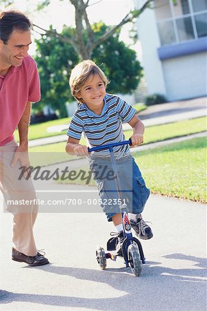 Father with Son Riding Scooter