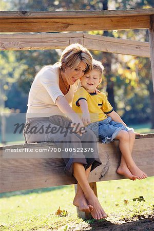Mother and Son Sitting On Fence