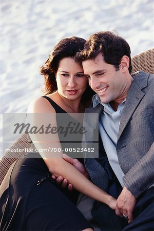 Couple Sitting in Chair On the Beach