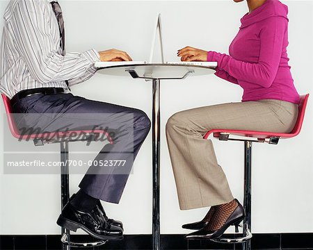 Two Business People using Laptops