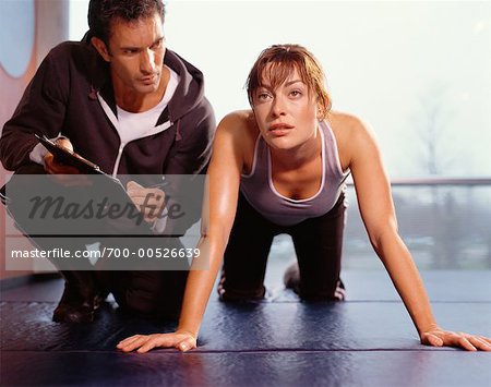Woman Exercising, With Personal Trainer
