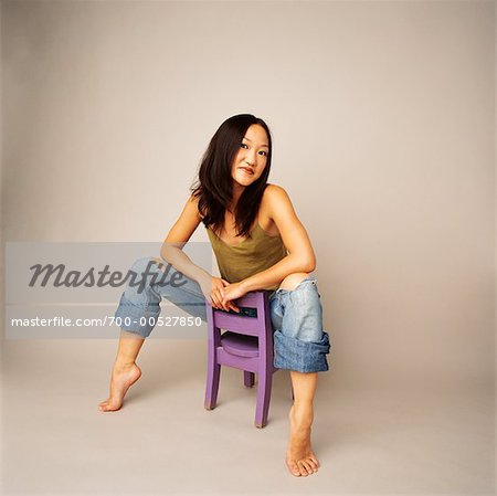 Girl Sitting on Giant Chair Stock Image - Image of barefeet