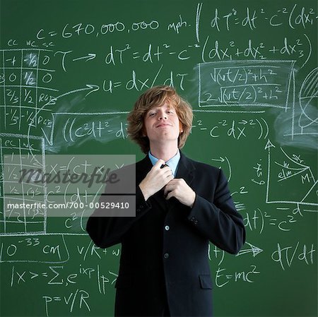 Portrait of Man Fixing Tie in Front of Chalkboard