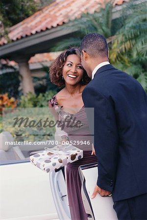 Couple in Formal Wear, Woman Holding Gift