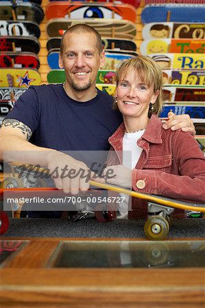 Couple with Skateboards in Store