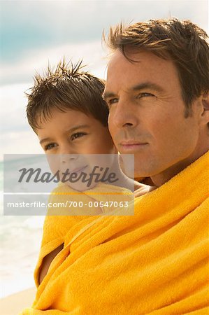 Father and Son Wrapped in Towel on the Beach