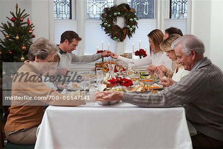 Family Praying at Christmas Dinner