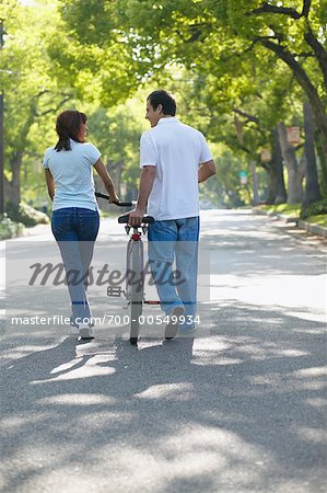 Couple Walking with Bicycle
