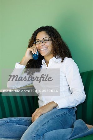 Woman on Sofa with Cordless Phone