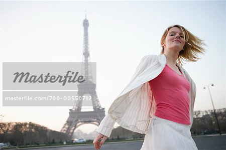 Woman by Eiffel Tower, Paris, France
