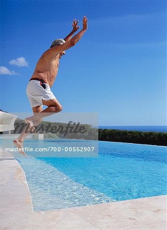 Man Jumping into Swimming Pool