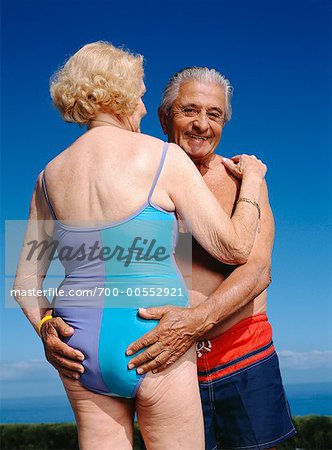 Booty old woman in a swimsuit on the beach Stock Photo