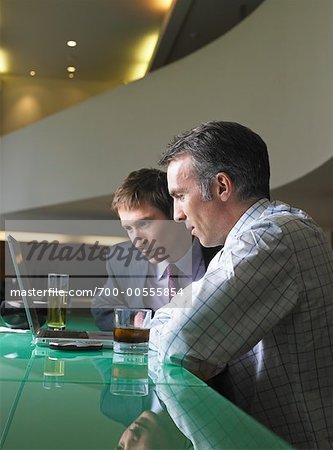 Businessmen Looking at Laptop