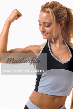 Female athlete flexing biceps stock photo