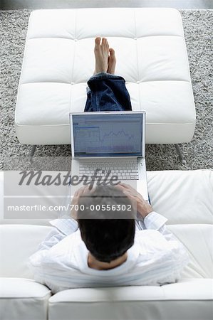 Man Using Laptop on Sofa