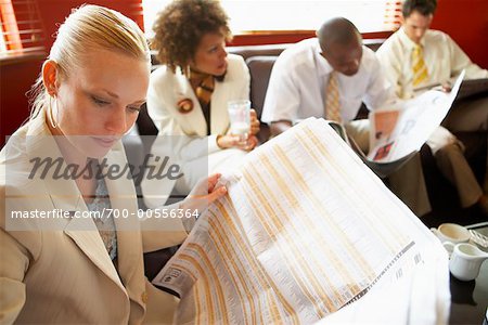 Business People Reading Newspaper