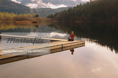 Woman Practicing Yoga on Dock