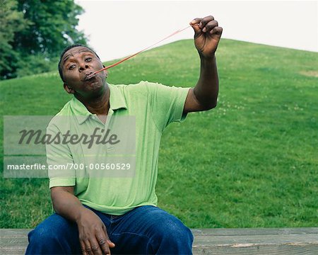 Portrait of Man Holding Gum from His Mouth