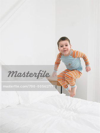 Boy Jumping on Bed