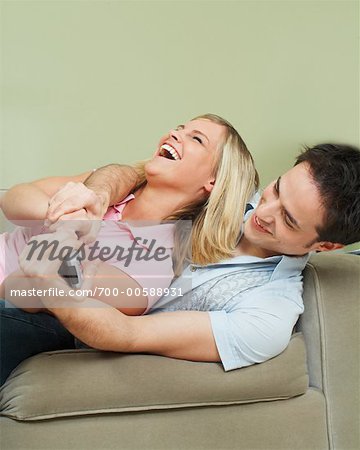 Young Couple Fighting for Remote Control