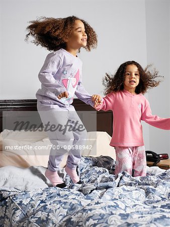 Sisters Jumping on Bed