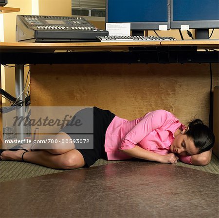 Woman Sleeping Under Desk Stock Photo Masterfile Rights