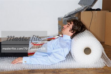 Businessman Sleeping on Bubble Wrap Stock Photo Masterfile