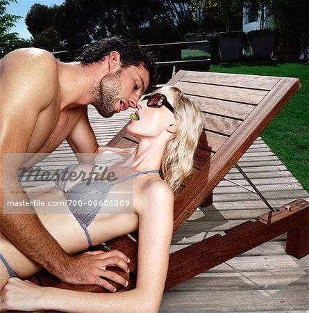 Couple Lying on Deck Chair