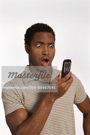 Man Reading Text Message, Looking Shocked - Stock Photo - Masterfile -  Rights-Managed, Artist: Reid Lincoln Ashton, Code: 700-00607095