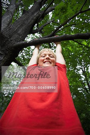 Portrait of Boy Hanging from Tree