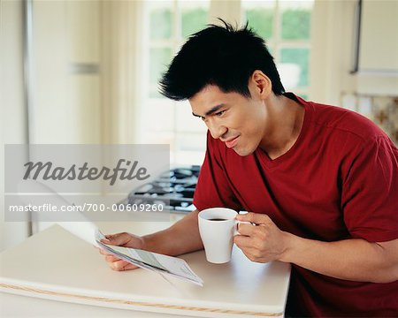 Man Drinking Coffee and Reading