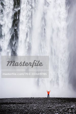 Person by Large Waterfall, Skogarfoss Falls, Iceland