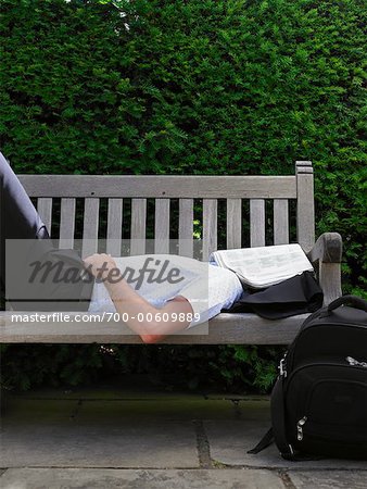 Man Lying Down on Park Bench