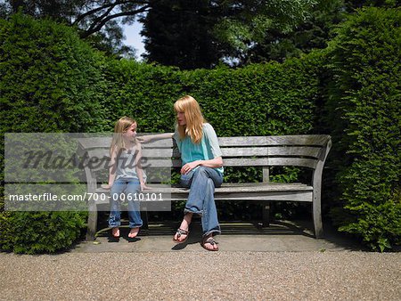 Mother and Daughter Sitting on Bench